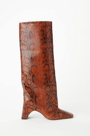 Brown snakeskin knee high boot with irregular heel.