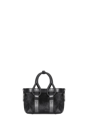 A black leather handbag with textured cowhide panels and black leather straps, shown against a plain white background.