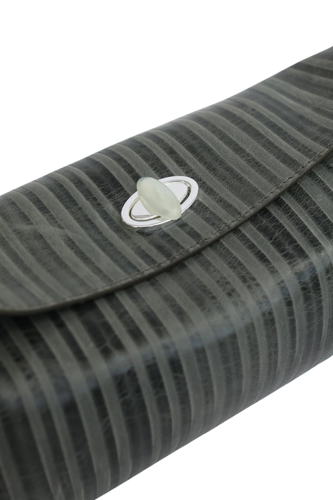 Close-up of a dark gray textured clutch bag with a striped pattern and a silver-toned oval clasp on a white background.