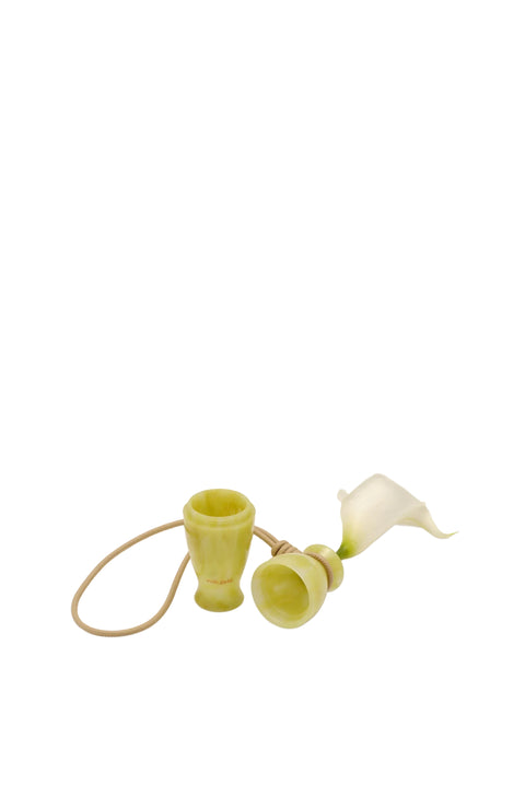 Small decorative calla lily bag charm opened up on a beige background