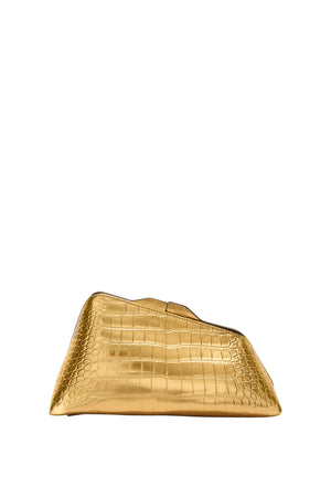 Gold clutch bag with crocodile texture on a light gray background