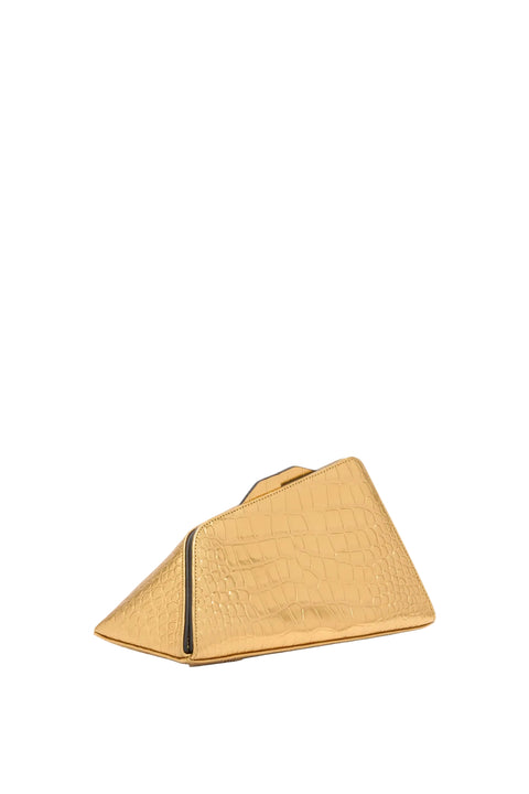 Gold clutch bag on a light beige background