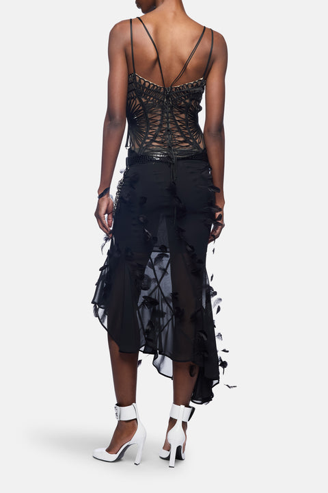 Black lace top and skirt set on a white background