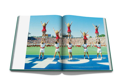 Open book showing a photograph of cheerleaders performing on a sports field.