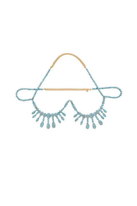 Beaded necklace bralette with a blue and gold design on a light gray background