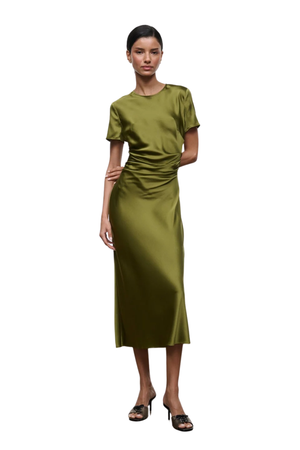 A woman modeling a short-sleeve olive green midi dress with a gathered, ruched waist, paired with brown heeled sandals, against a plain white background.