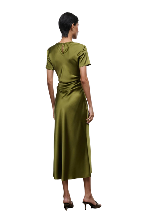 A woman shown from the back wearing a short-sleeve olive green midi dress with a draped waist detail and a small keyhole cutout at the neckline, paired with black heels, against a plain white background.