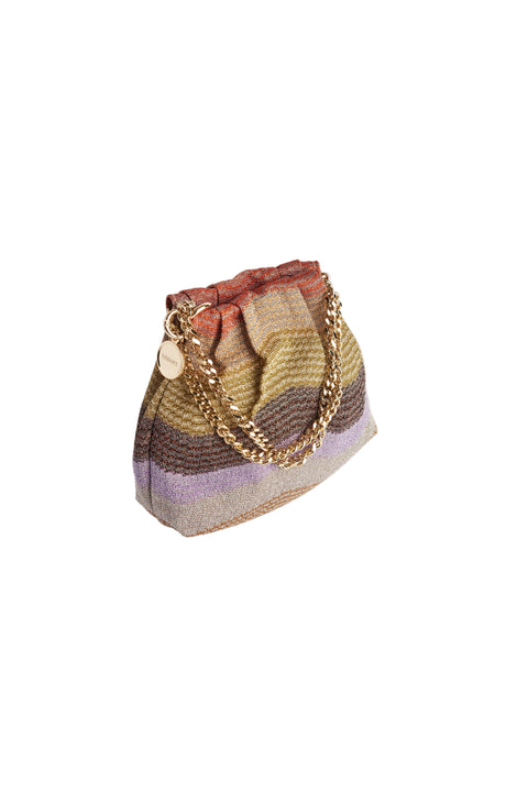 A small woven bucket bag with horizontal stripes in beige, brown, purple, and rust, featuring a gold-tone chain strap and a round wooden charm, set at an angle. 