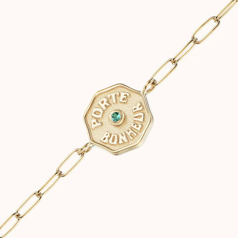 Up close of yellow gold 'Porte Bonheur' amulet and chain attached.