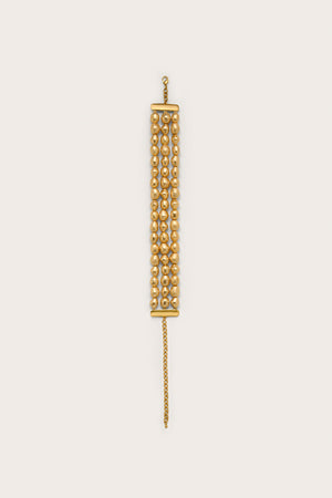 A choker style necklace crafted from three rows of gold-foiled wooden beads and gold hardware. 