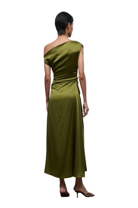 A woman shown from the back wearing a one-shoulder olive green satin midi dress, paired with black pointed-toe heels, against a plain white background.