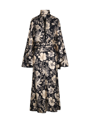 A long-sleeved midi dress with a high collar and a matching waist tie, featuring an all-over floral pattern in beige and cream on a black background, shown against a plain white background.