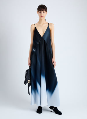 Women in strappy blue ombre maxi dress.