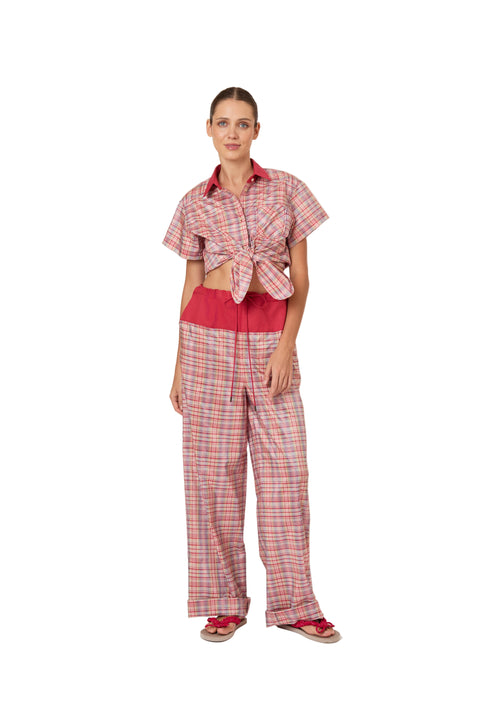 Woman wearing a red and white checkered outfit on a white background