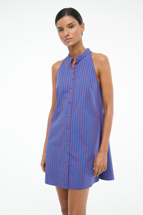 Close up of a woman wearing a red and blue stripe poplin mini dress that features a stand collar and front button closure. 