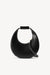 A small, black leather, moon-shaped handbag that features an optional crossbody strap. 