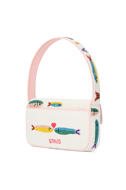 Back of a white glass-beaded shoulder bag that depicts two multicolor sardines kissing with a small red heart above them on the back, with rainbow sardines depicted on the shoulder strap. 