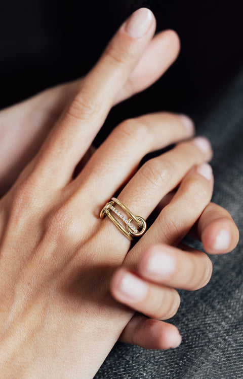 Close up of a woman wearing a Spinelli Kilcollin Sonny YG ring.
