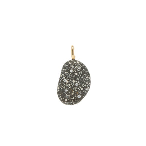 A black and white speckled stone pendant that is accented by small round diamonds and set with a gold bail. 