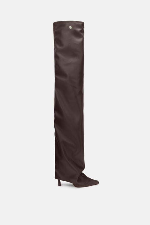 Ghost image of a dark brown, faux leather, over-the-knee thigh high boot that features a pointed toe, stiletto heel, and layered slouch effect. 