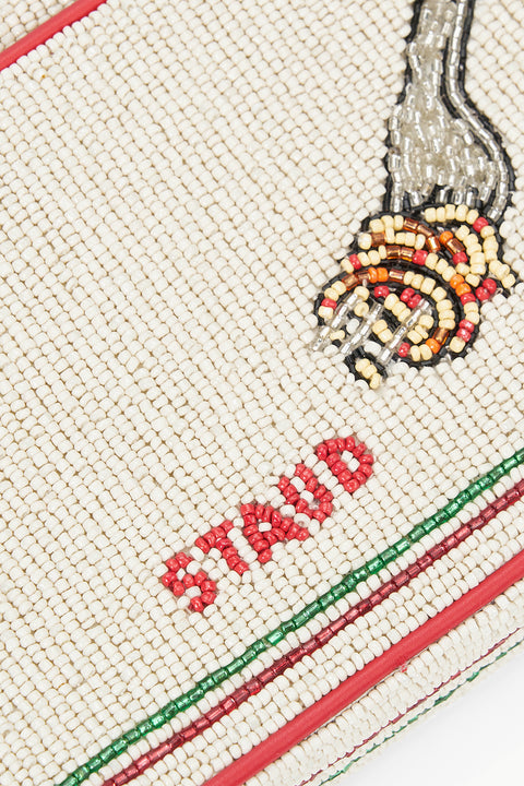 Detail shot of a glass beaded shoulder bag that features an icon of spaghetti and sauce wrapped around a fork. 