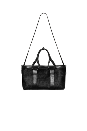 A black leather handbag with dual top handles and a long shoulder strap, displayed against a solid white background.