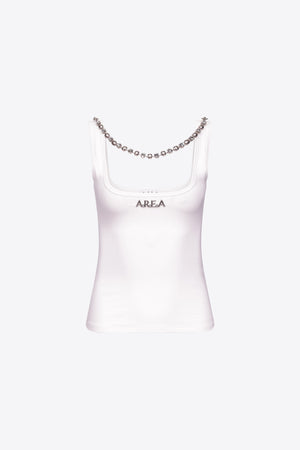 White tank top with area nameplate and crystal necklace.