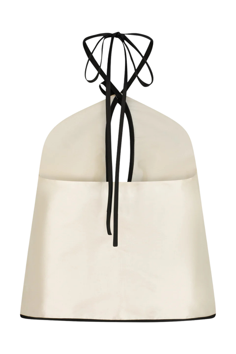 A white taffeta halter top with cutouts and black stitching
