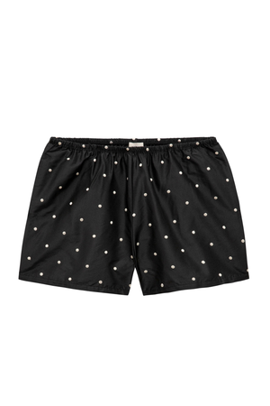Black women's shorts with a white polka dot pattern, featuring an elastic waistband and drawstring closure, shown flat against a white background.