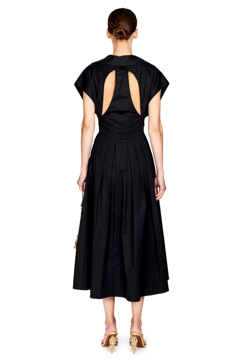 A model shown from the back wearing a black midi dress with short cap sleeves, a gathered waist, and a large cutout keyhole back design, paired with gold high-heeled sandals against a white background.