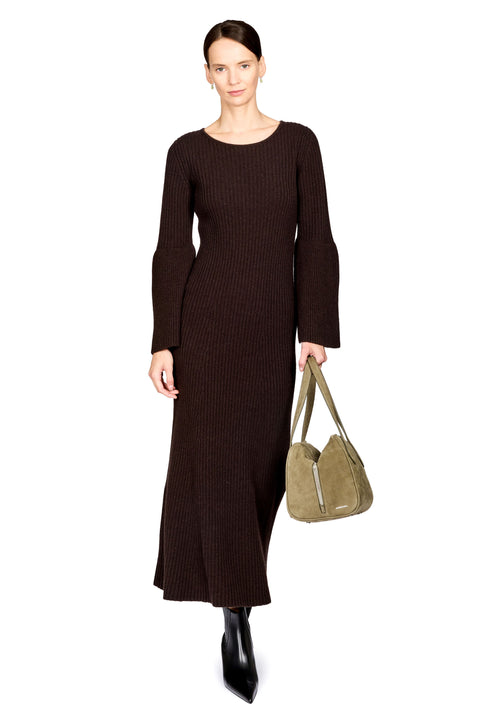 A woman modeling a long-sleeved, dark brown ribbed knit midi dress, holding a taupe suede shoulder bag and wearing black pointed-toe ankle boots, against a plain white background.