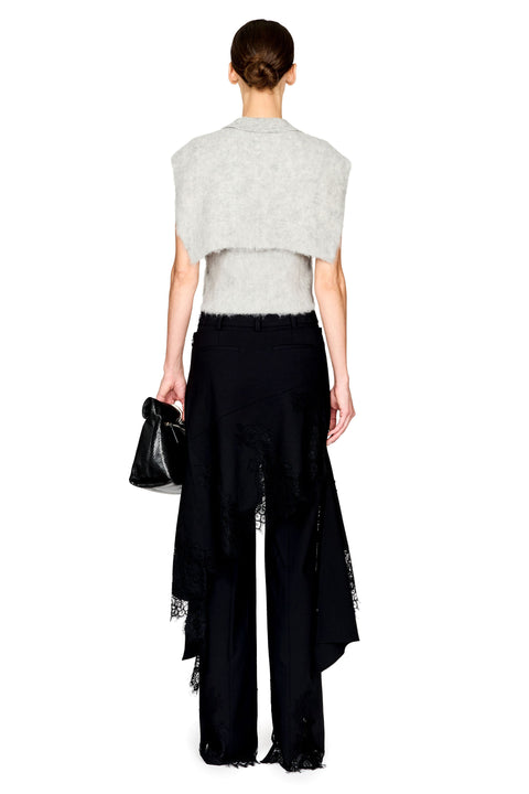 A model shown from the back wearing a light gray fuzzy cropped shrug over a white top and black wide-leg trousers with lace trim, holding a small black handbag against a plain white background.