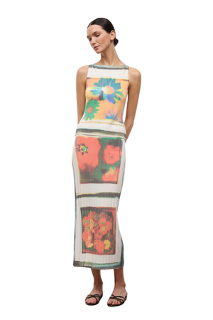 Woman wearing a floral patterned two piece skirt set on a white background