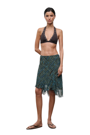 Woman wearing a blue and brown patterned midi skirt on a white background