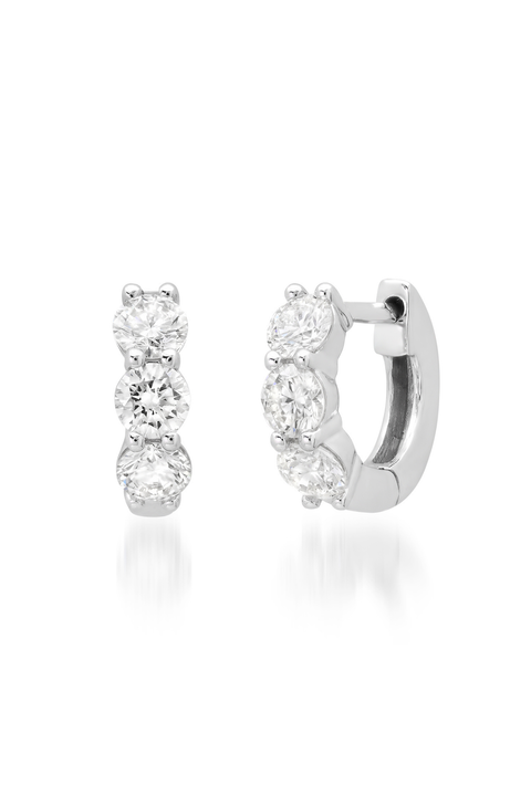 Pair of silver diamond hoop earrings with clear gemstones on a white background